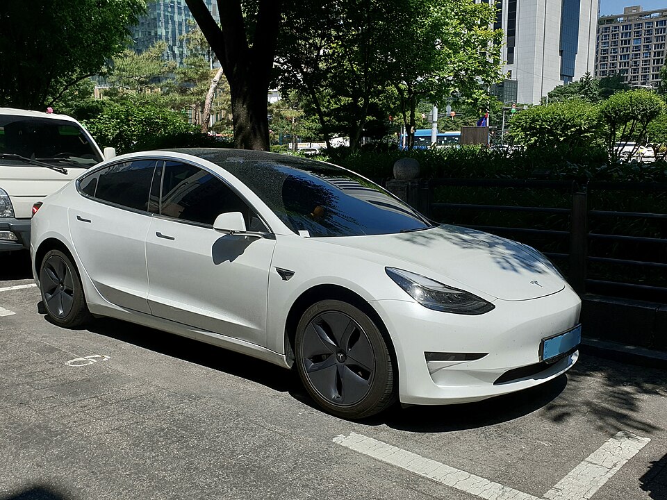 White Tesla Model 3, front three-quarter exterior.