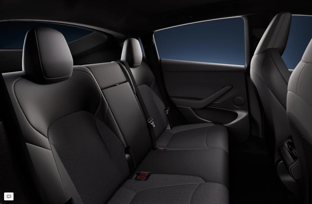 Tesla Model Y rear cabin with factory black seats, pillars, and headliner.