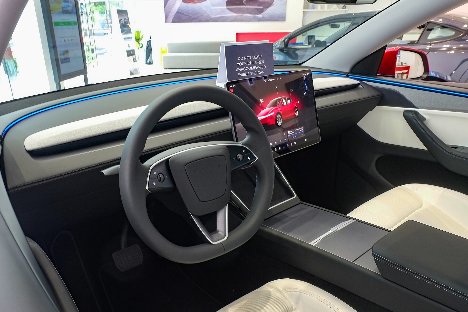 Tesla Model Y showroom cabin with factory light-grey headliner and A-pillars, 2020–2025.