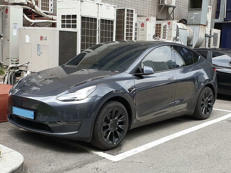 Grey Tesla Model Y, front three-quarter exterior.
