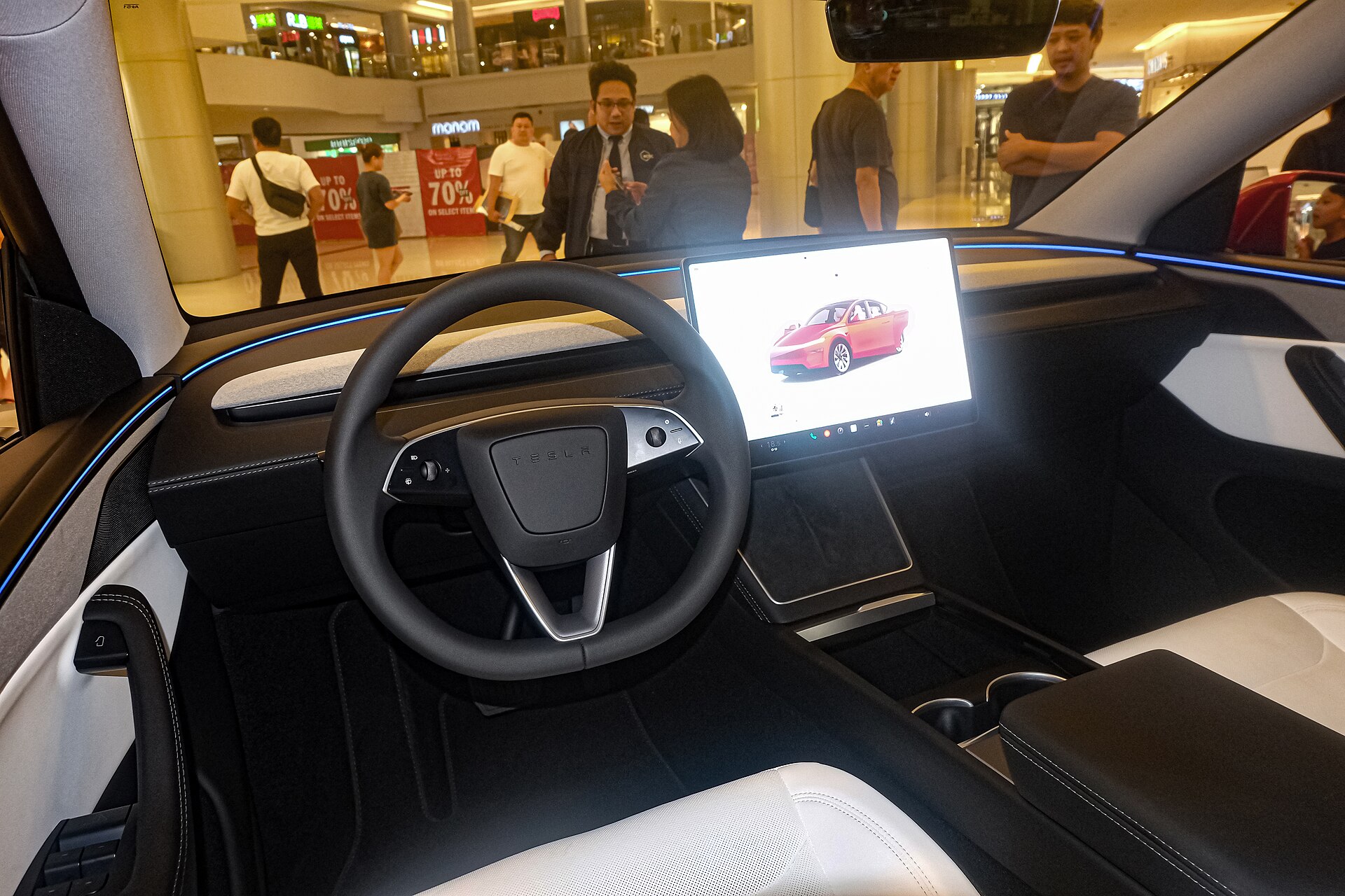 Tesla Model Y Juniper Long Range cabin with white seats and black dashboard.