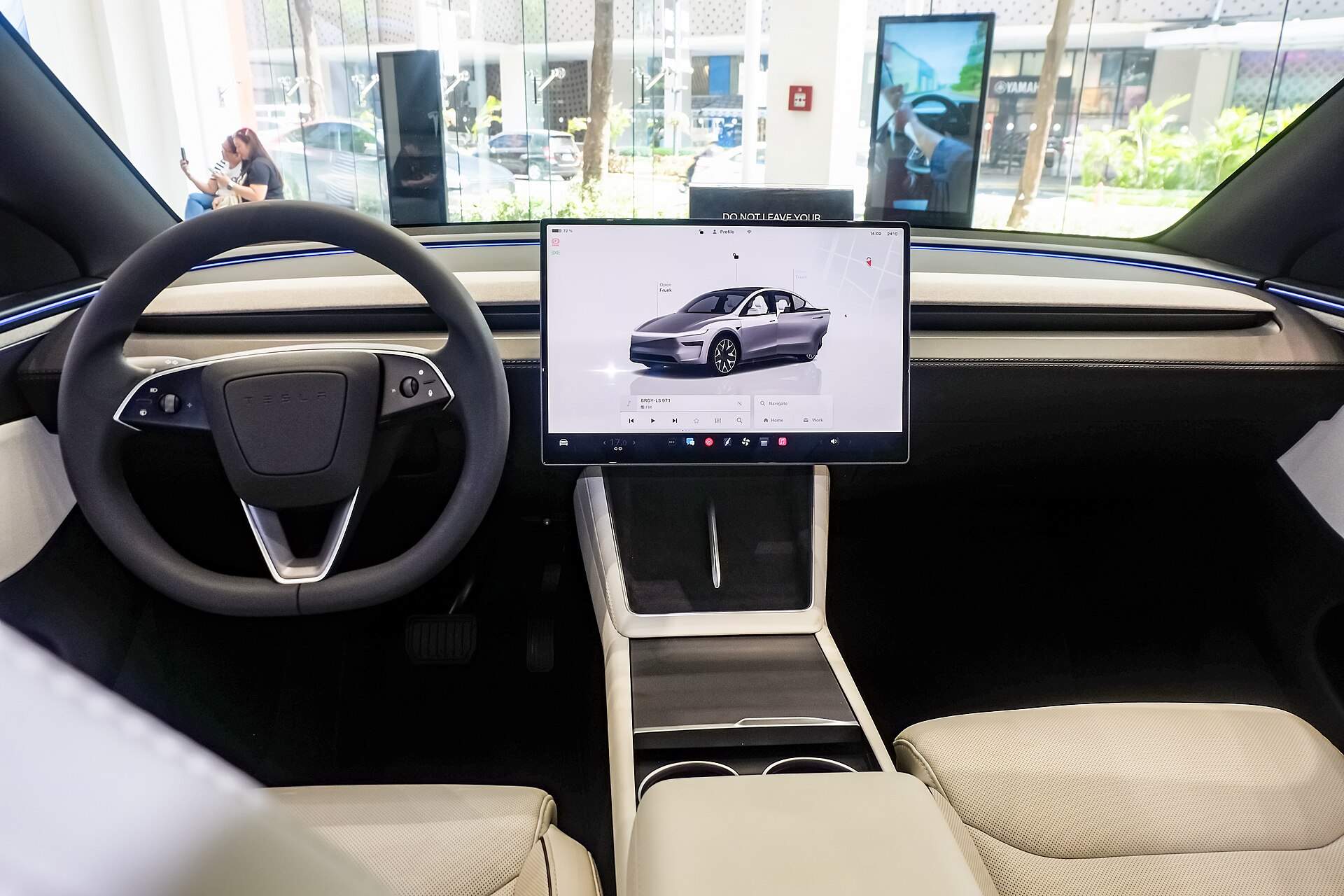 Tesla Model Y L Premium Long Range showroom cabin, wide front view with dual-tone interior.