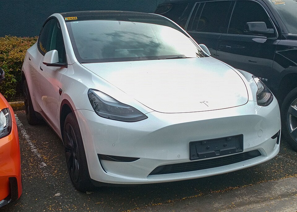 Pearl White Tesla Model Y Long Range, front three-quarter exterior.